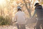 Mother and daughter bike riding in woods