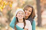 Portrait enthusiastic mother and daughter hugging outdoors