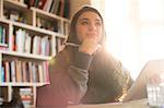 Pensive teenage girl with digital tablet