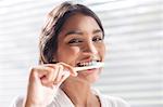 Close up portrait smiling woman brushing teeth