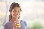 Portrait smiling woman drinking orange juice