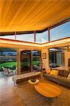 Illuminated wood ceiling over luxury living room open to patio