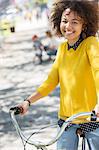 Portrait smiling woman on bicycle in park