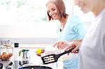 Smiling women cooking in kitchen