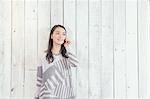 Young Japanese woman on the phone in a stylish office