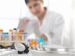 Female doctor inspecting blood sample at desk