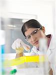 Female scientist examining chemical sample in lab