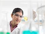 Female chemical scientist developing formula in laboratory