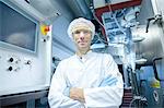 Portrait of male scientist with arms crossed in lab cleanroom