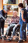 Nurses with smiling senior man in care home