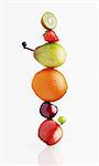 Stacked fruit on white background