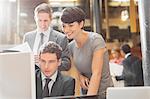 Smiling business people working at computer in office