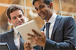 Businessmen working with digital tablet in office