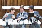 Business people with digital tablet on office balcony