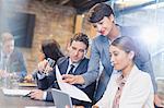 Business people with paperwork and digital tablet in conference room