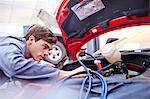 Mechanic working on car engine