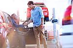 Mechanic and customer handshaking in auto repair shop