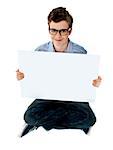 Smiling boy holding a blank whiteboard. Copy space concept