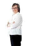 Female employee posing with crossed arms in front of camera wearing eyeglasses