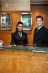 Trendy adorable couple at front office desk for customer assistance