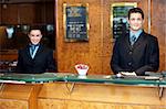 Front desk colleagues posing for a picture. Smiling cheerfully while looking at camera