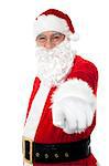 Elderly cheerful Santa pointing at you. Christmas holiday concept.