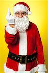 Angry Santa showing middle finger. Isolated on yellow background.