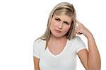 Studio shot of a thoughtful teen girl posing against white background.