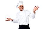 Young smart male chef welcoming his guests