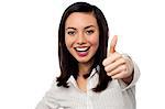 Smiling Asian corporate woman gesturing thumbs up