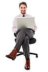 Businessman sitting on the chair with laptop