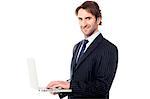 Young businessman operating his laptop