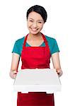 Young female chef delivering pizza
