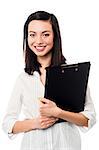 Female executive in formals holding business files, half length shot.