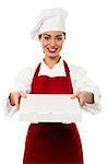 Young female chef delivering pizza, isolated on white background.