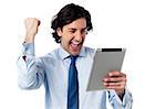 Business executive holding touch pad. Full of enthusiasm.