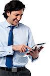 Young businessman operating tablet device