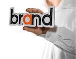 Caucasian man holding a brand name, copy space on the left side of the image. Identity concept over white background.