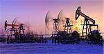 oil pumps at sunset sky background. panorama.