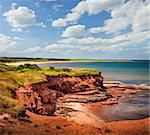 Red cliffs of Prince Edward Island Atlantic coast at East Point, PEI, Canada.