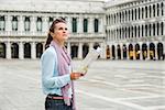 Perhaps she's looking at the Belltower, or perhaps at the Doges Palace. But whichever way she decides to go, this elegant woman tourist knows it will be a feast for the eyes.