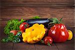 Fresh vegetables in basket on wooden board