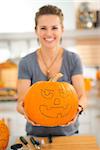 Woman with big scary pumpkin Jack-O-Lantern for Halloween. Closeup