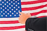 Businessman pointing with his finger against rippled us flag