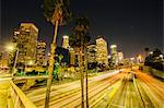 View of city skyline and highway at night, Los Angeles, California, USA