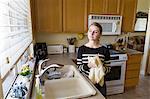 Woman daydreaming in kitchen