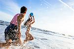 Young couple fooling around in sea