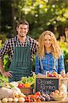 Couple selling organic vegetables at market