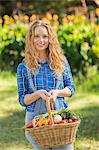 Smiling woman with basket of vegetables