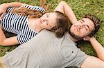 Cute couple resting in the grass in the park